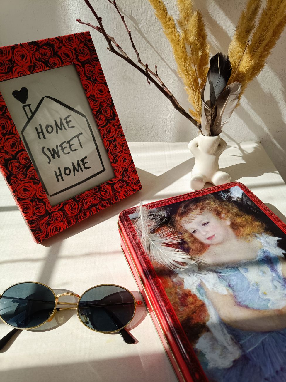 Decorative tin boxes repurposed as creative home storage solutions, neatly organized on a shelf.